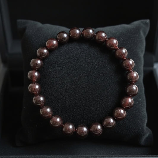 Natural reddish-brown Garnet bracelet on a black jewellery cushion