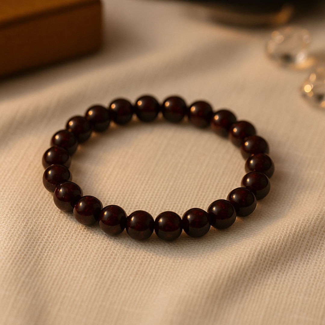 Reddish-brown Garnet bracelet on cream linen in warm light