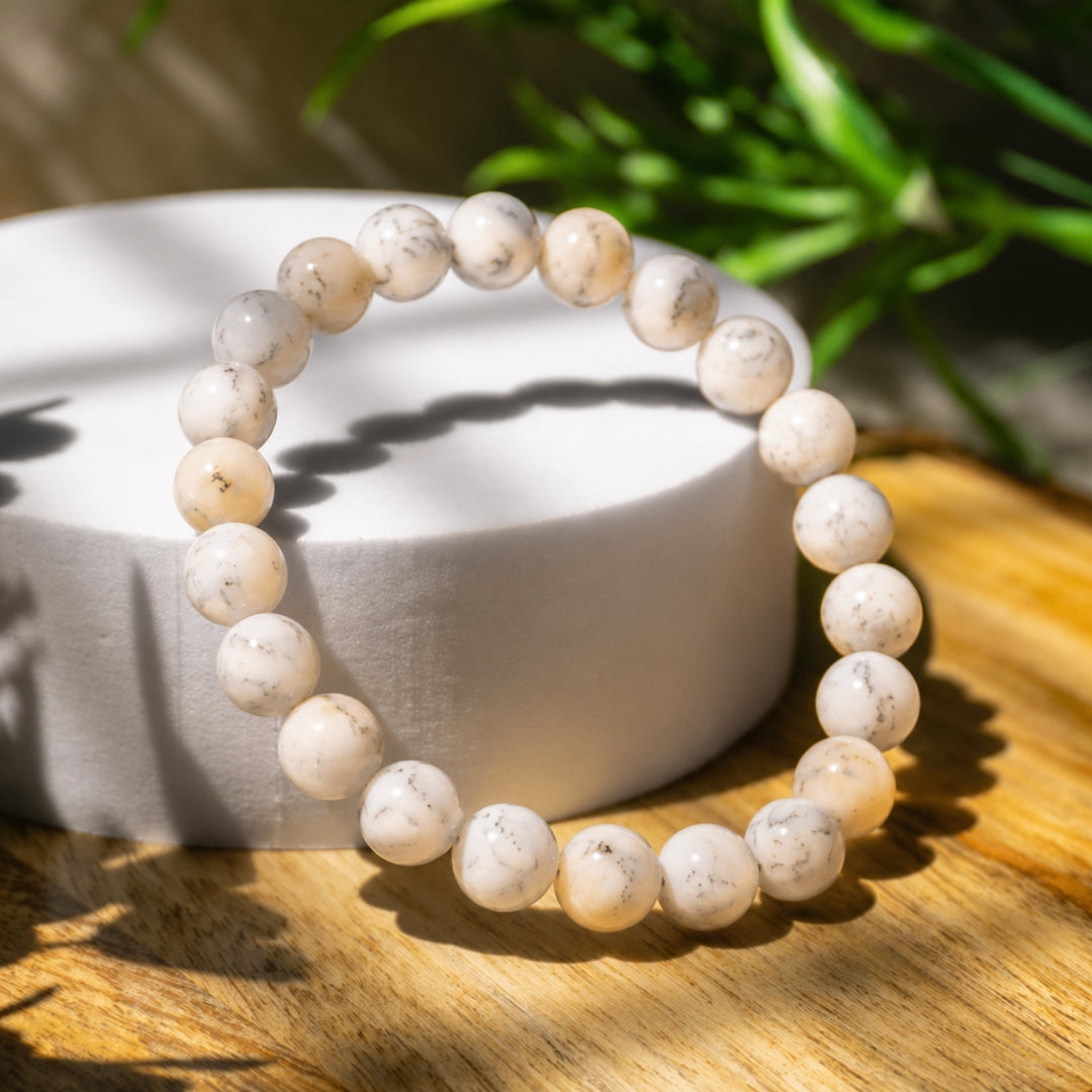 White and cream Opal bracelet beside a white display stand