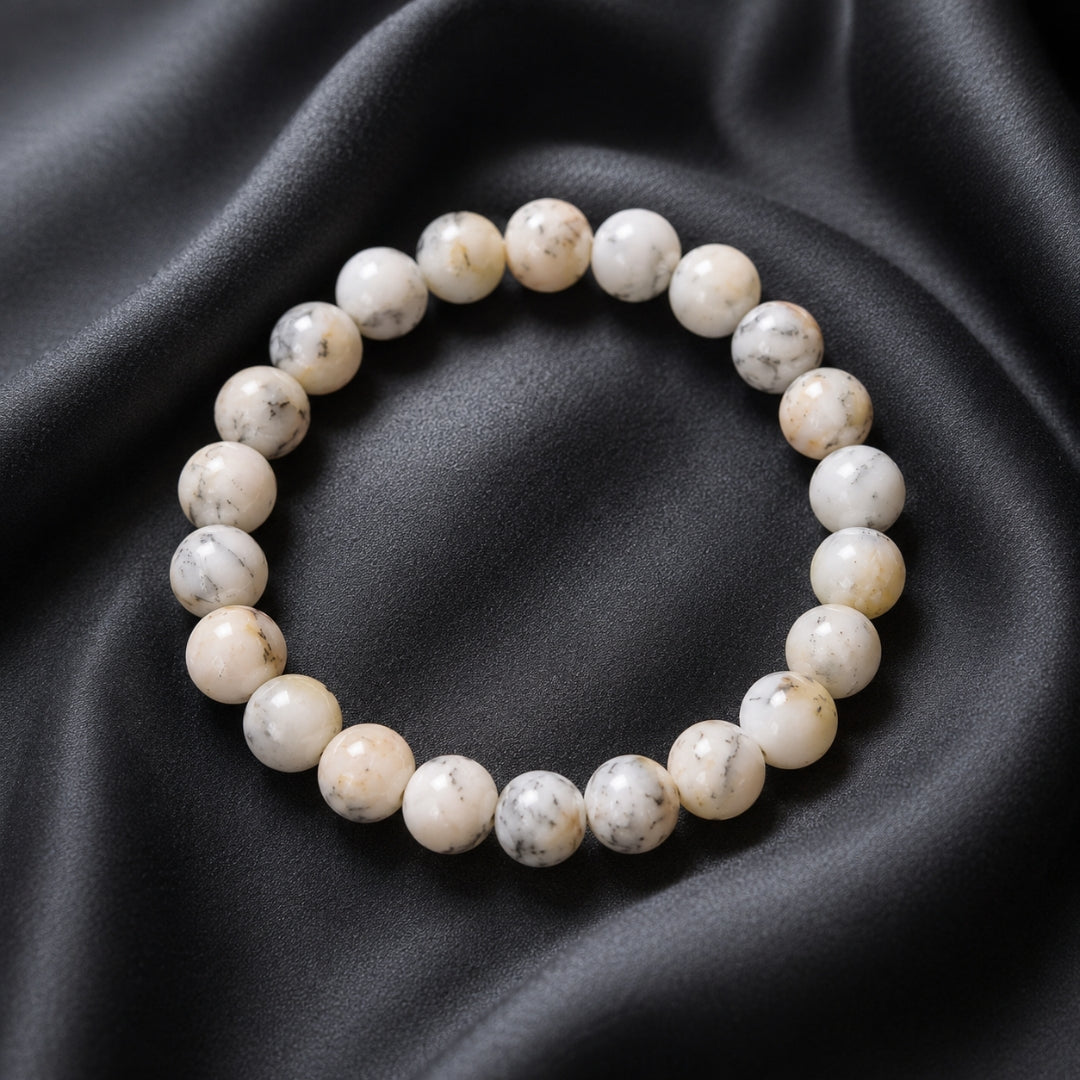White Opal bead bracelet with darker markings on black fabric