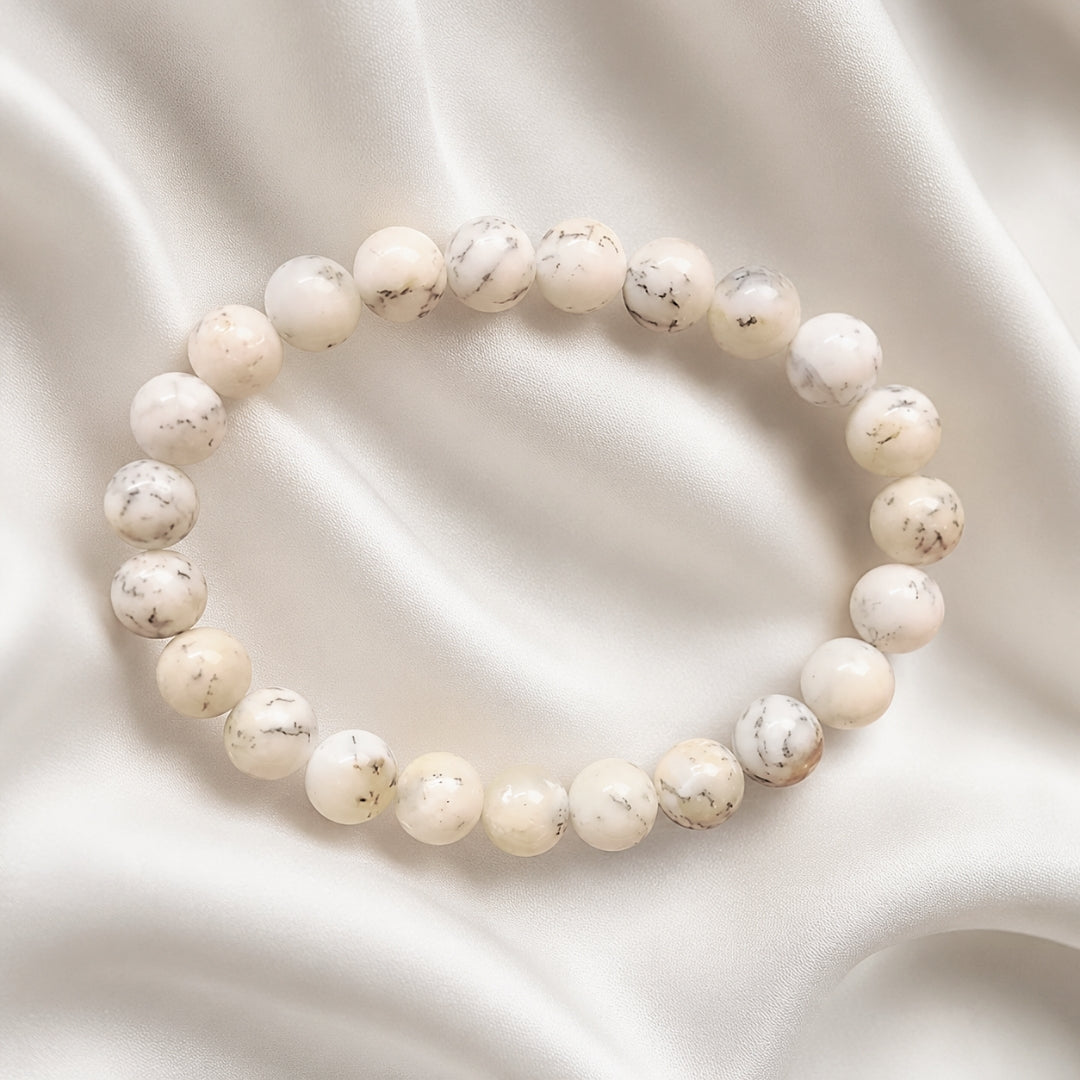 White Opal bracelet with delicate dark markings on cream fabric