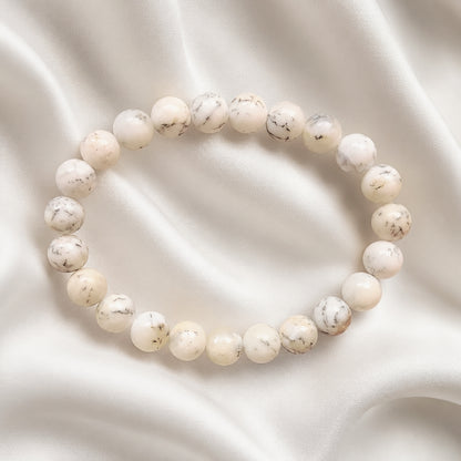 White Opal bracelet with delicate dark markings on cream fabric