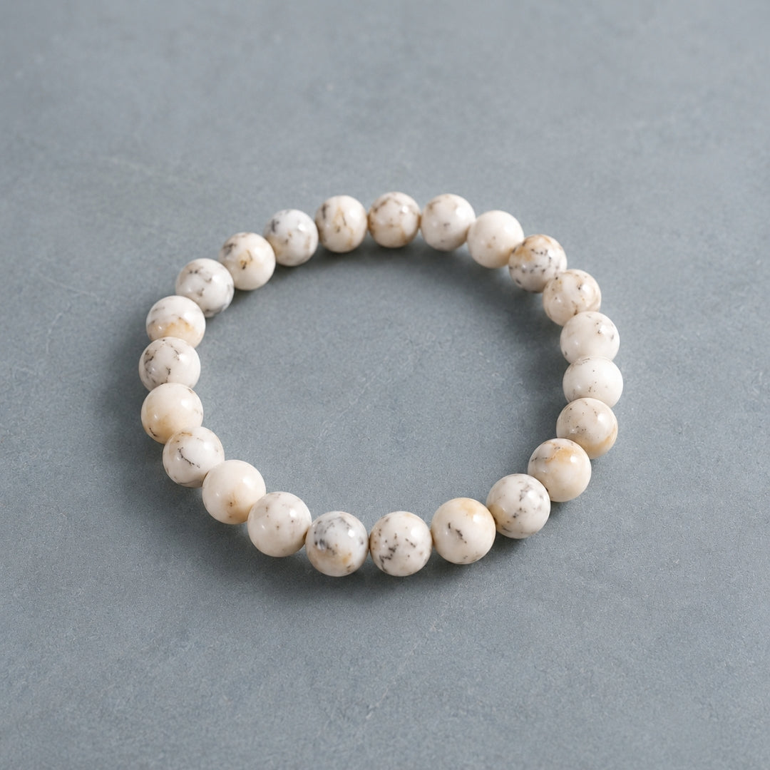 Round white Opal bead bracelet on a grey background
