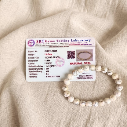 White Opal bracelet beside its SRT Gems Testing Laboratory certificate