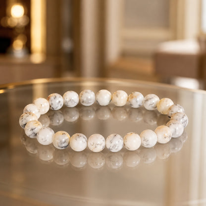 Natural white Opal bracelet on a reflective surface in warm light